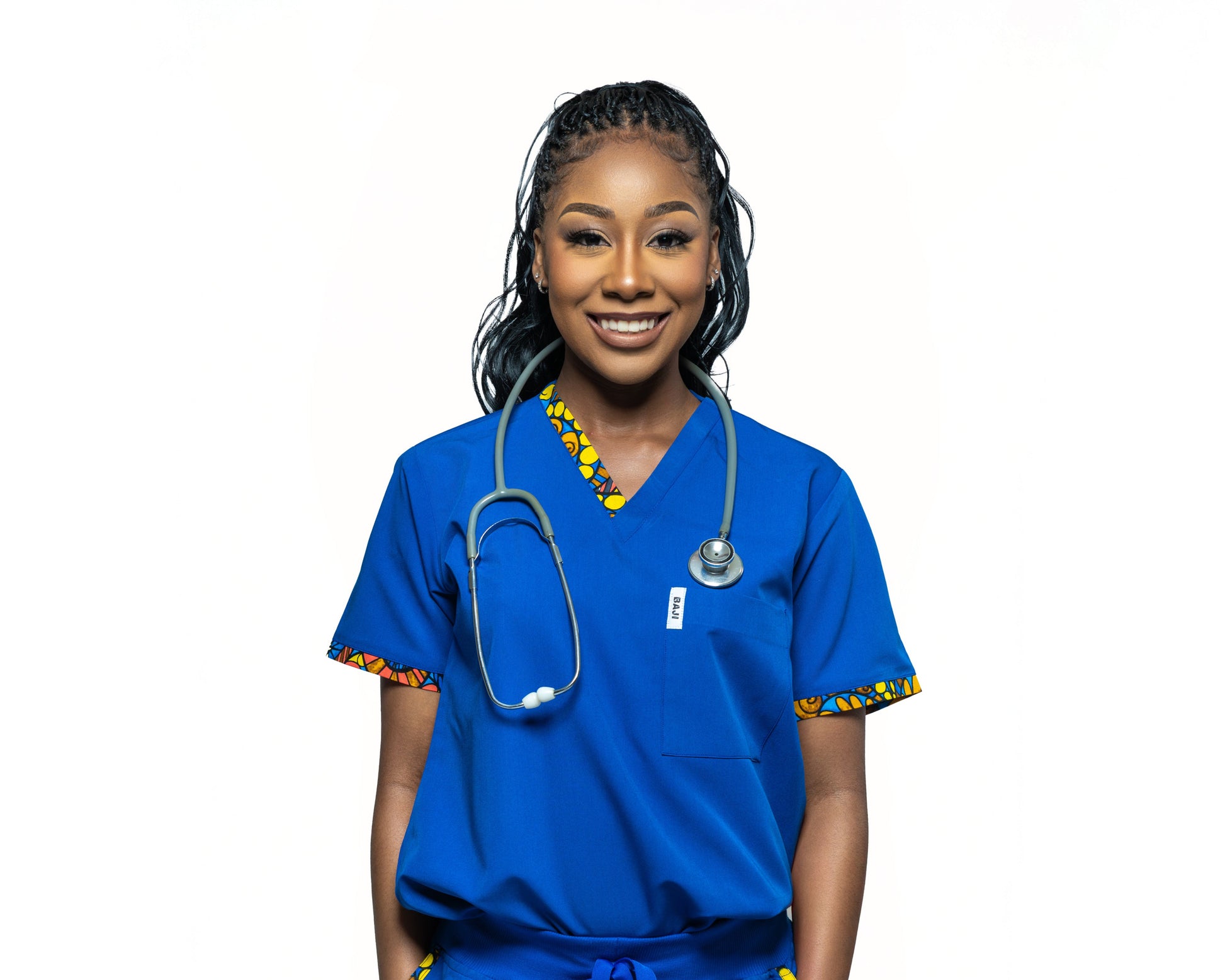 A female model wearing a blue V-neck scrub top with a single chest pocket.