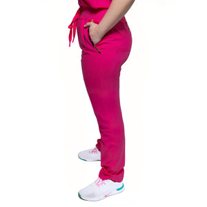 A person wearing pink female Nia Scrub Pant with decorative detail on the knee area.