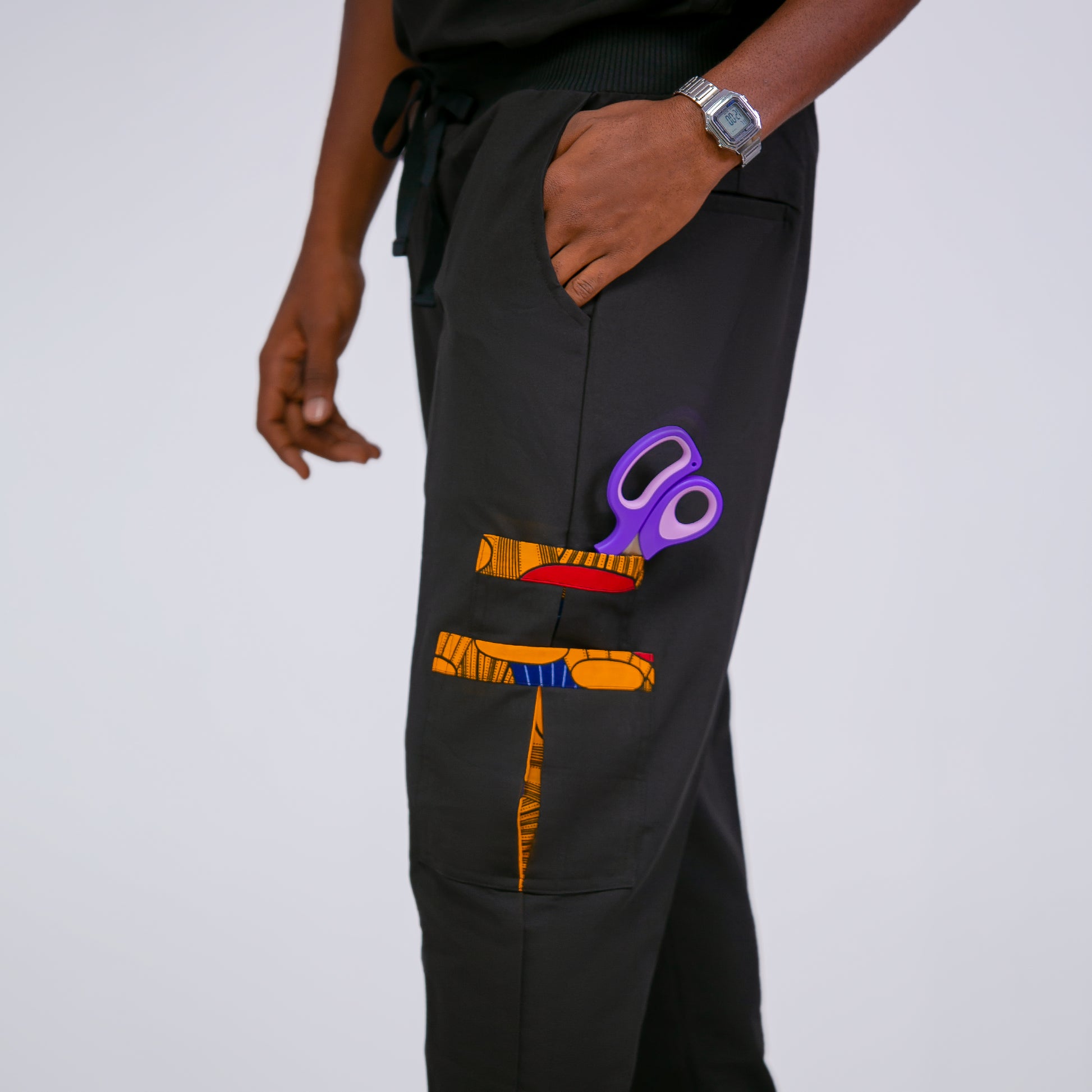 Black pants with colorful scissors design on a white background