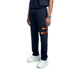 Person wearing black scrubs pant with a colorful design on a white background