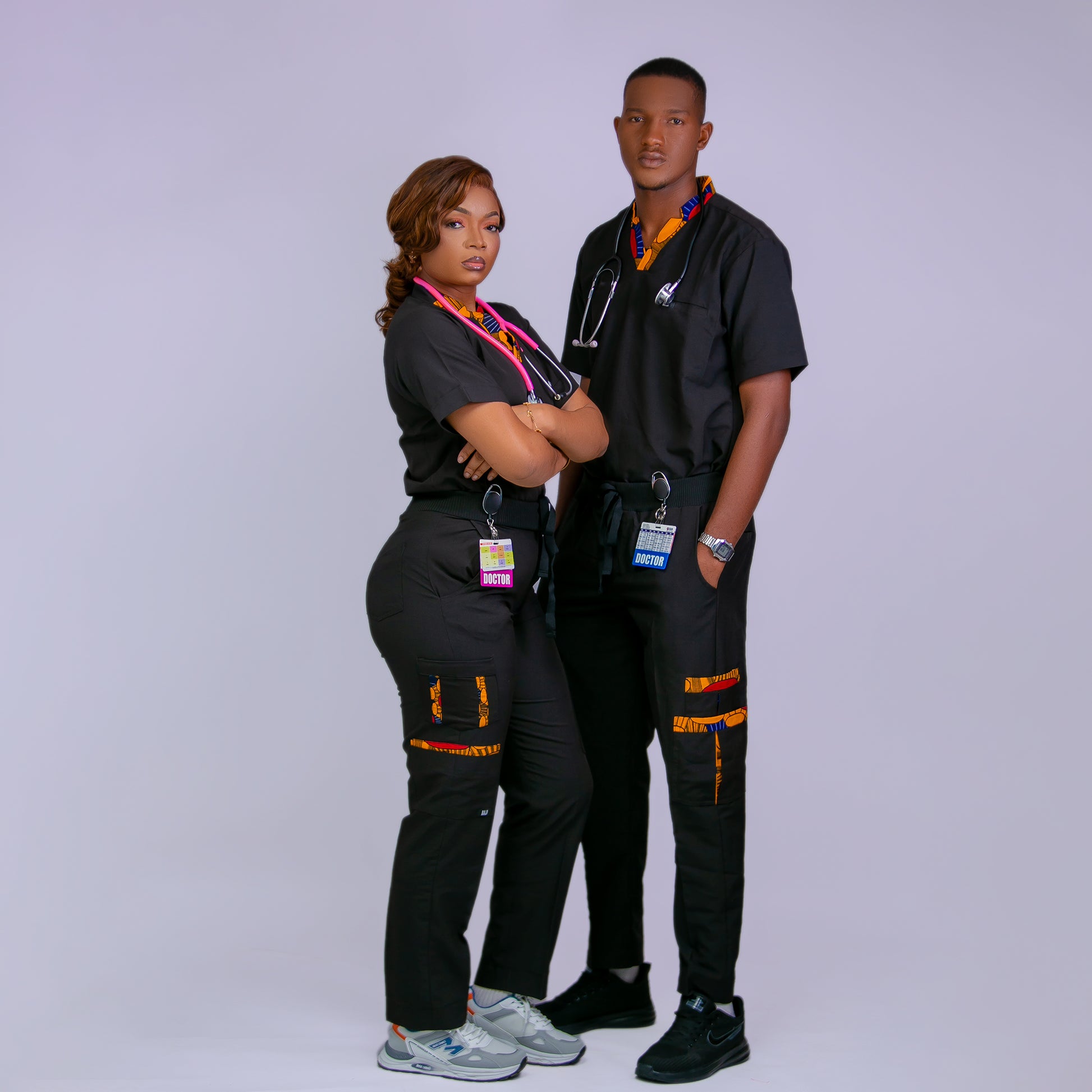 Two healthcare professionals in black uniforms with colorful accents on a white background